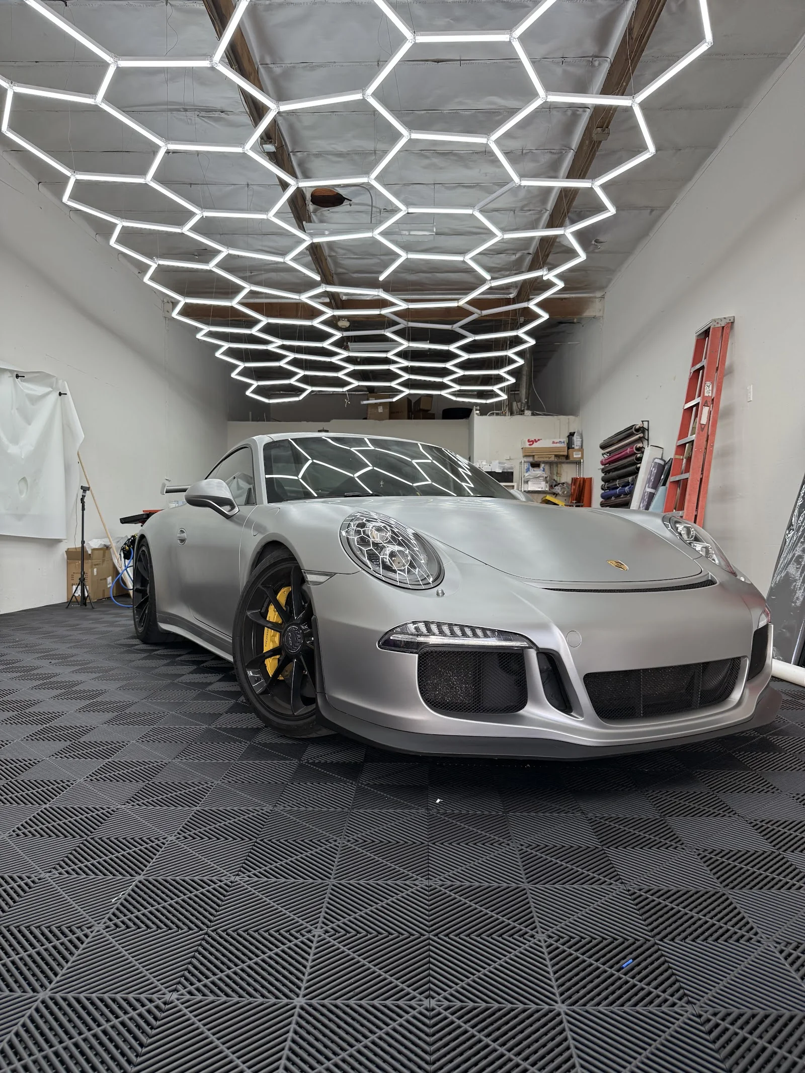 Silver Porsche 911 freshly tinted inside the Ace of Spades Customs shop