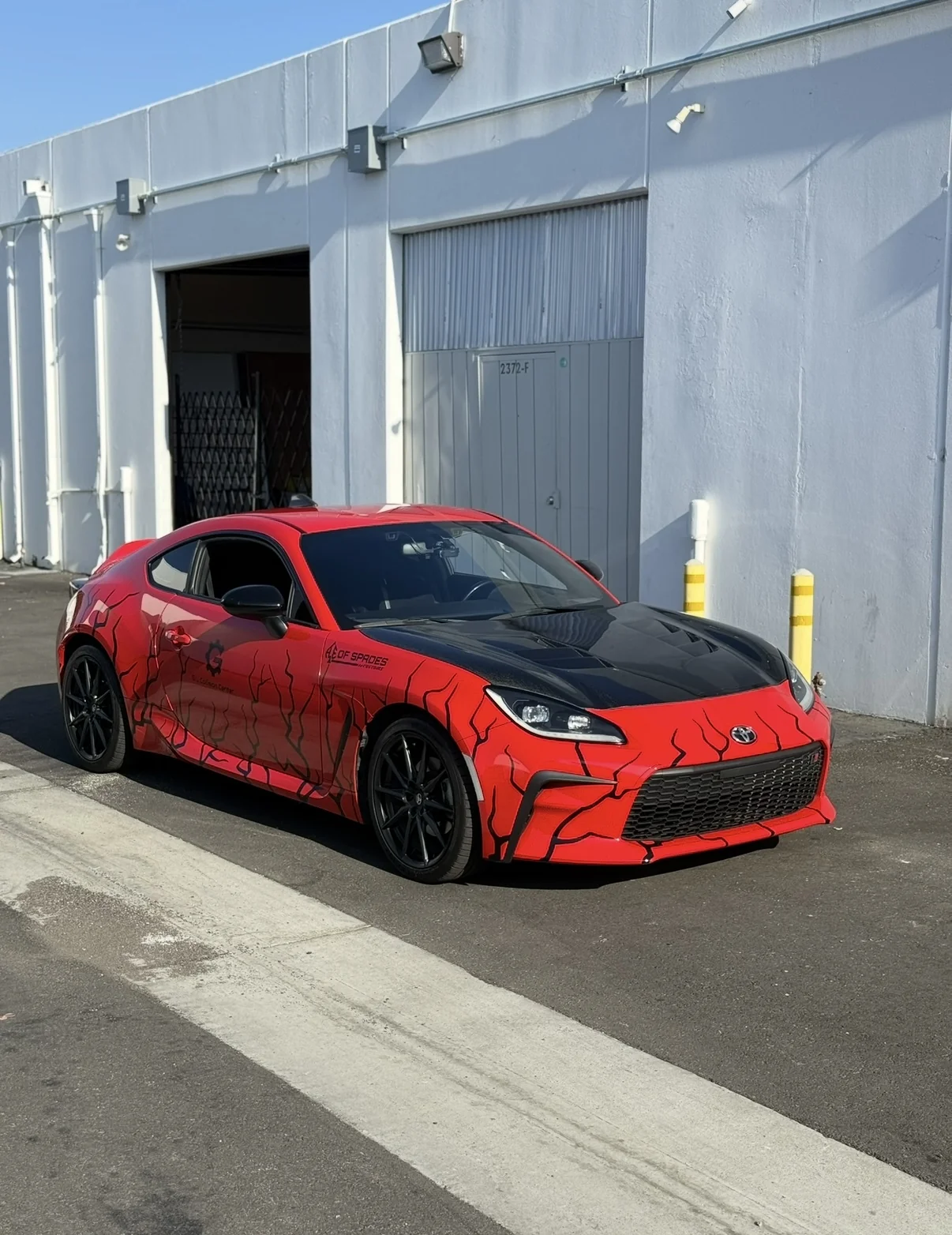 Custom red Ace of Spades wrap on a Toyota GR86 build